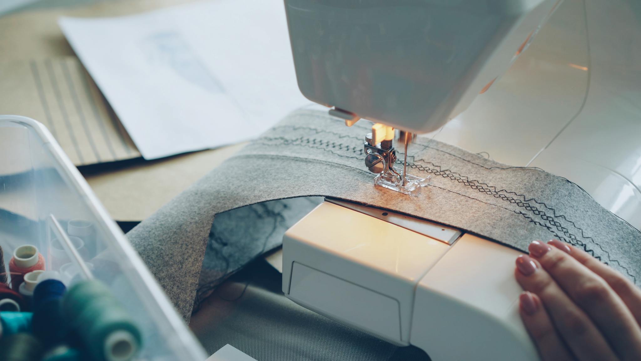 Detailed view of a sewing machine stitching fabric, showcasing DIY and crafting.