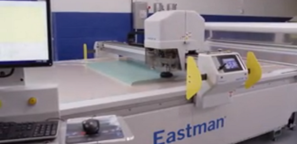 A semi-automatic fabric cutting machine in use at a garment workshop reliable workhorse for mid-scale fabric cutting operations